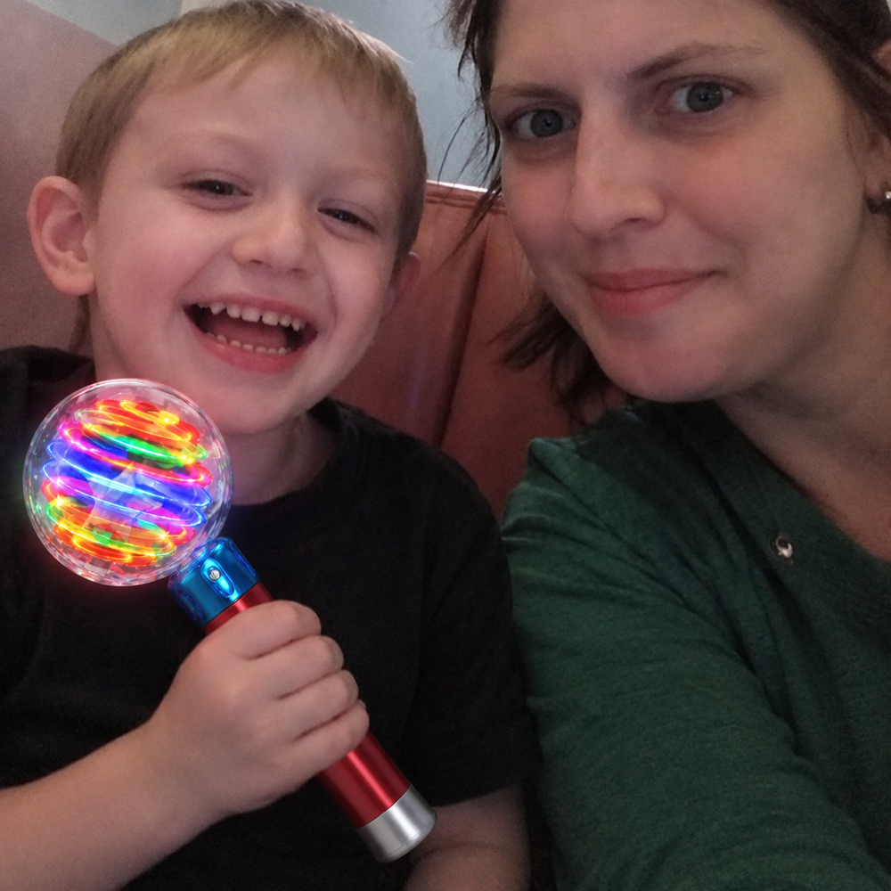 Family photo edited to show the Mimsy Glow & Spin Sensory Wand