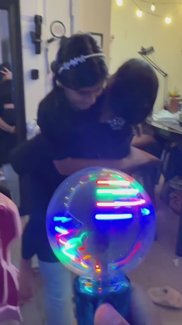 A close-up of the Mimsy Glow & Spin Sensory Wand.
