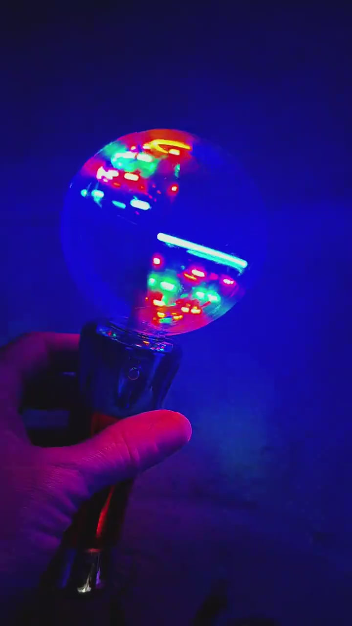 A parent shows the Mimsy Glow & Spin Sensory Wand for play.